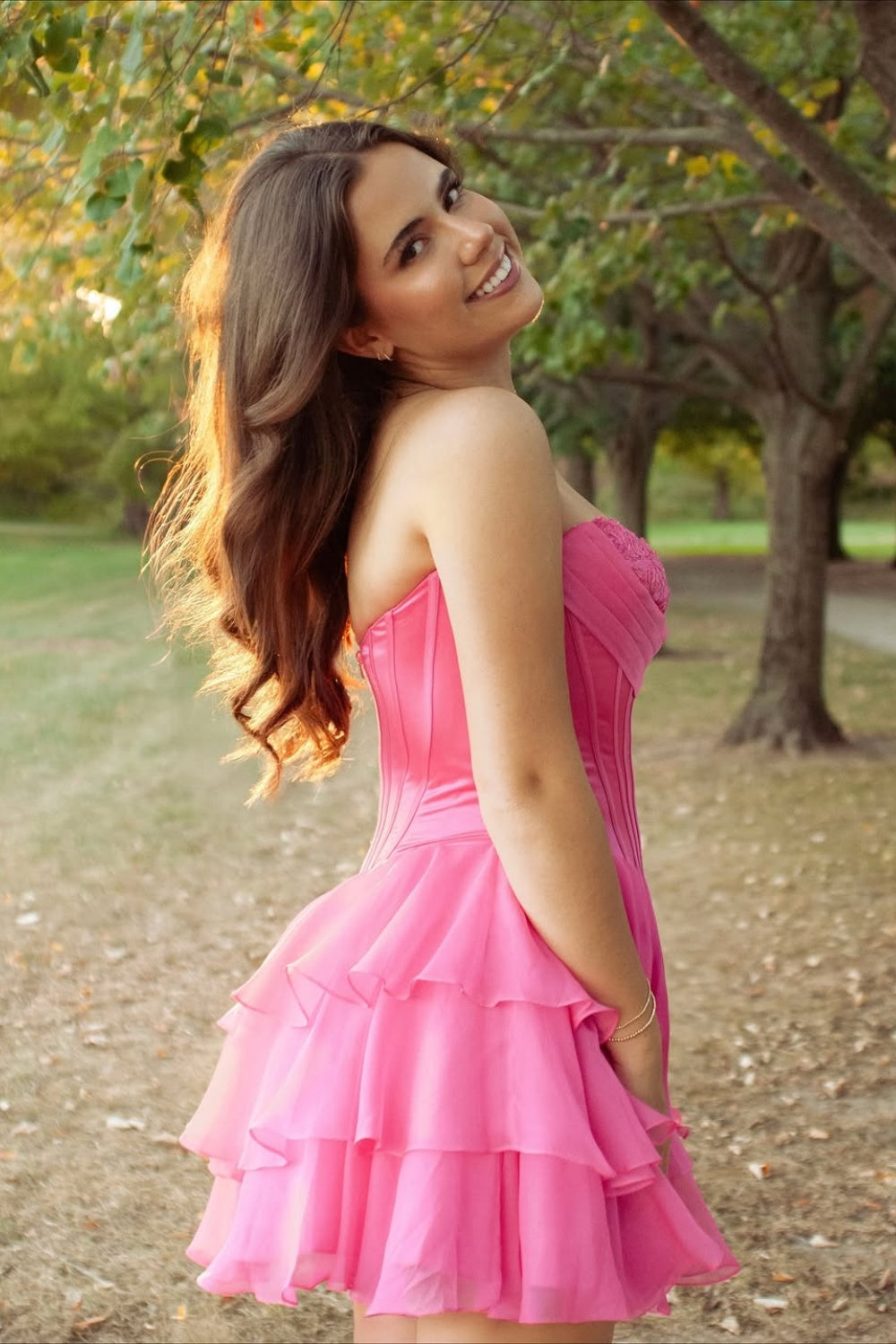 Pink sweetheart corset dress with lace appliques and A-line skirt.