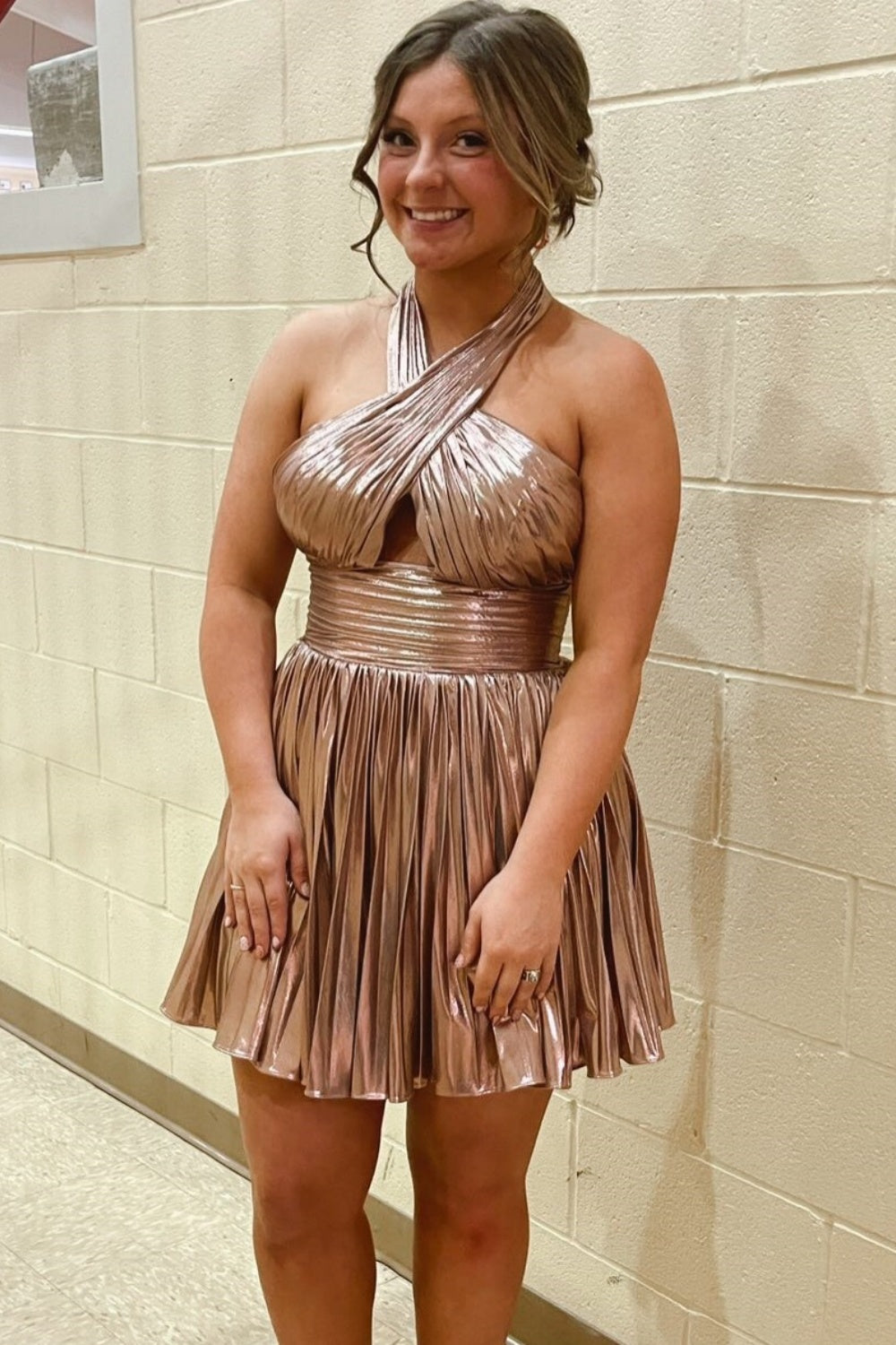 Metallic gold halter A-line homecoming dress with pleated skirt.