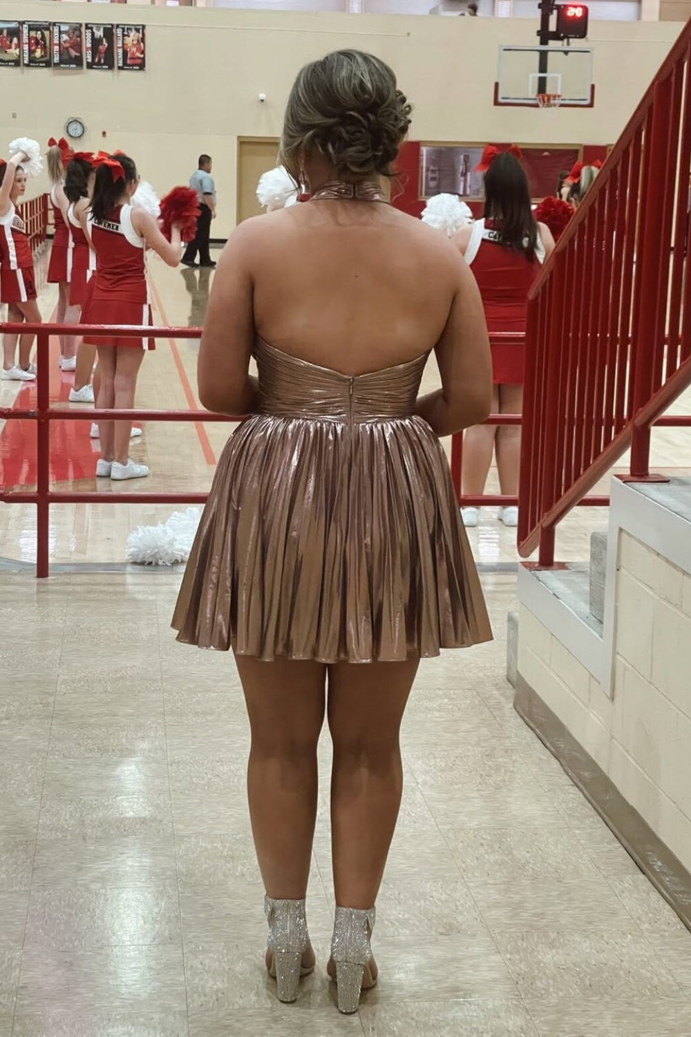 Metallic gold halter A-line homecoming dress with pleated skirt.