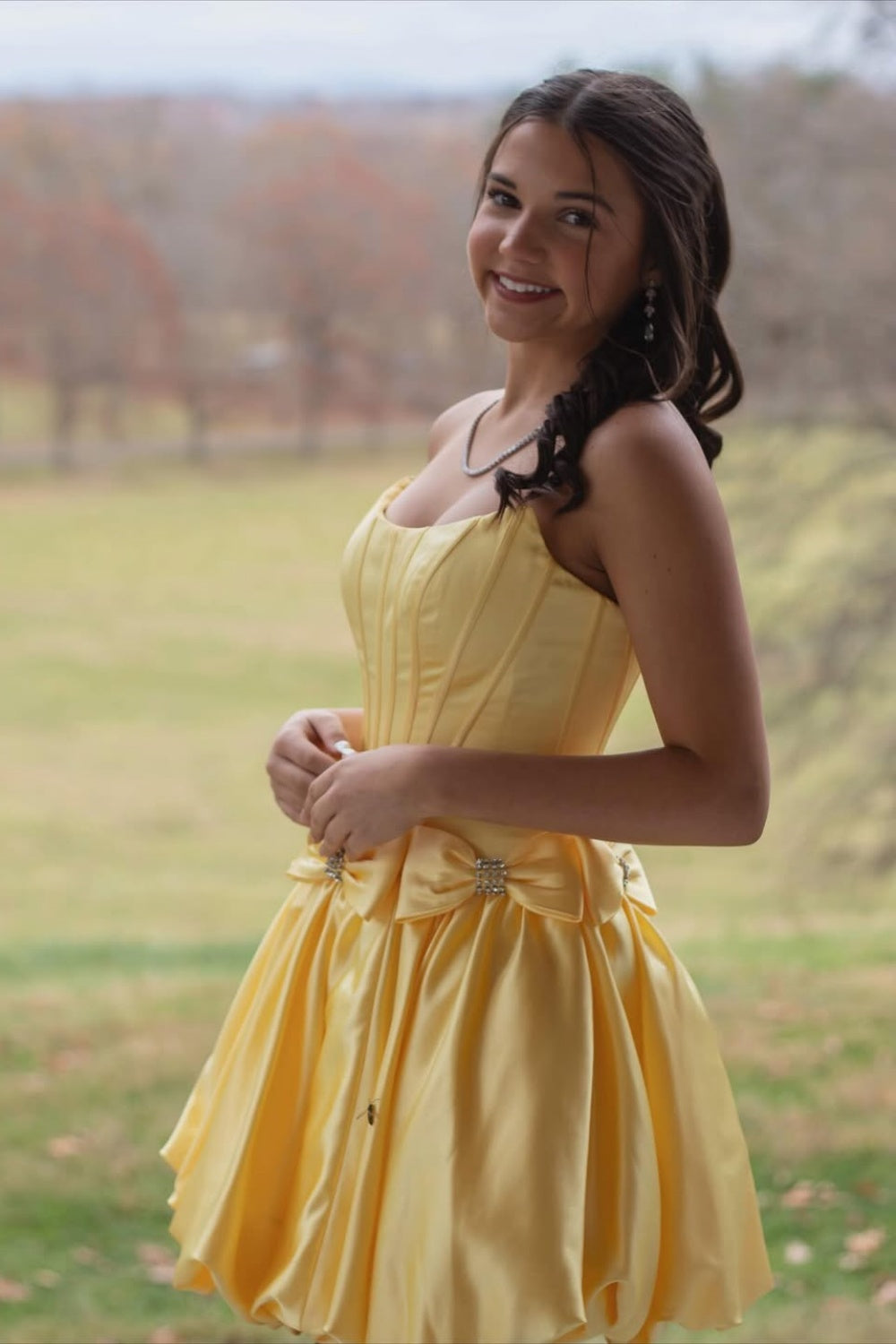 Yellow strapless A-line mini dress with a wrap-around bow.