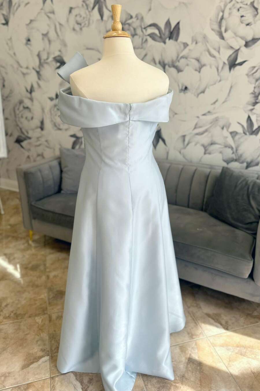 Light blue strapless long Mother of the Bride dress with bow neck detail.