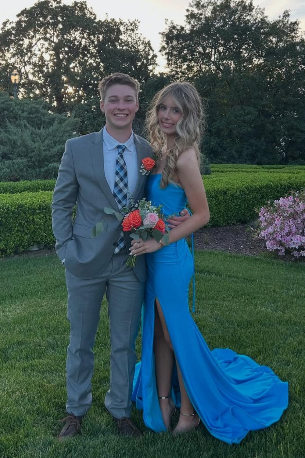 Strapless royal blue satin mermaid prom dress with side slit and ruching.