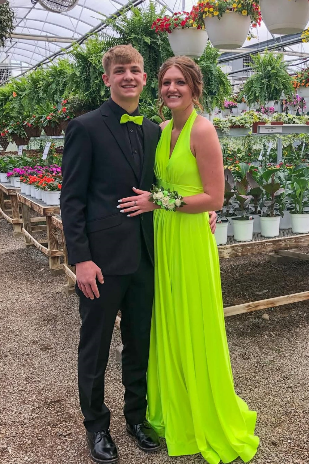 Slime green A-line long formal dress featuring a halter neckline, ruched detailing, and an open back design