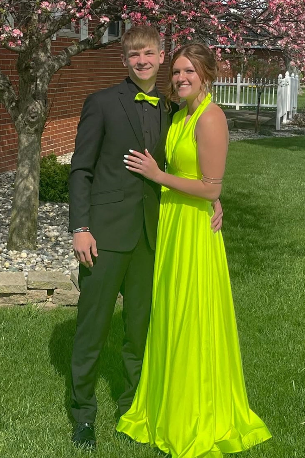 Slime green A-line long formal dress featuring a halter neckline, ruched detailing, and an open back design
