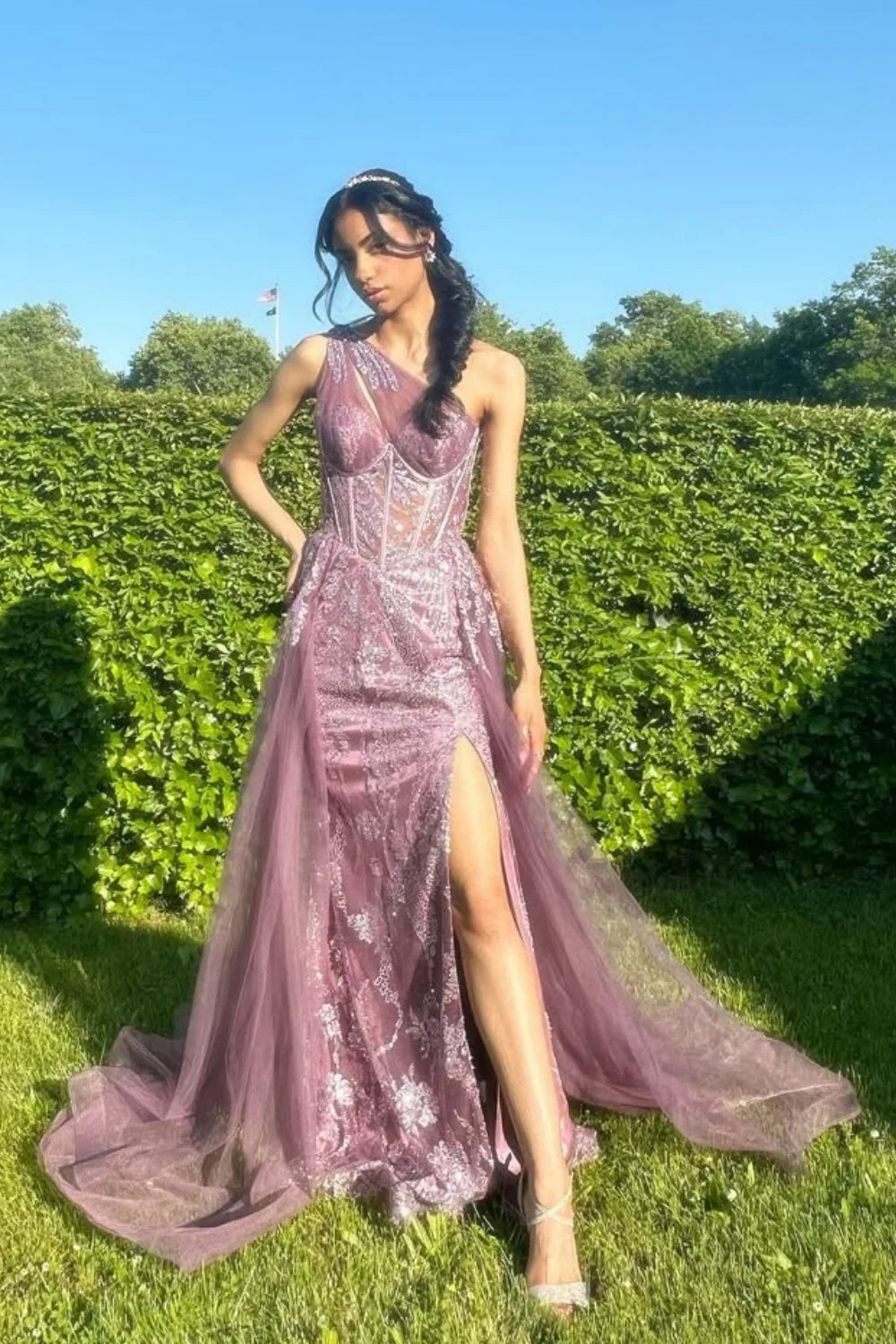 One-shoulder dusty rose A-line tulle gown featuring sequin embroidery and a structured corset bodice.