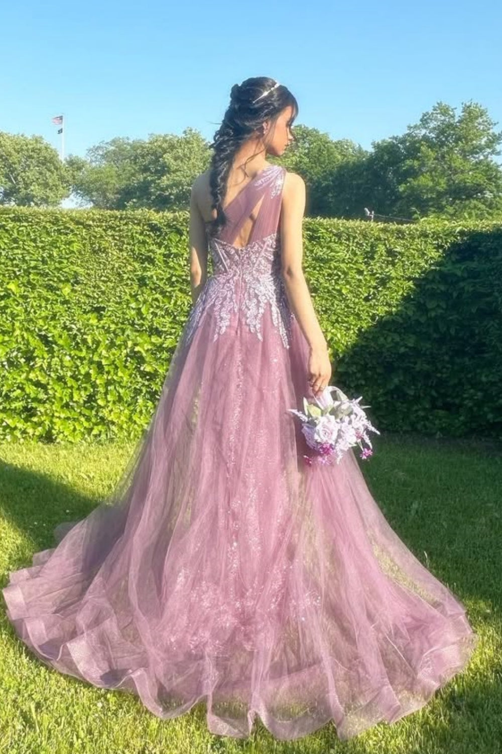 One-shoulder dusty rose A-line tulle gown featuring sequin embroidery and a structured corset bodice.