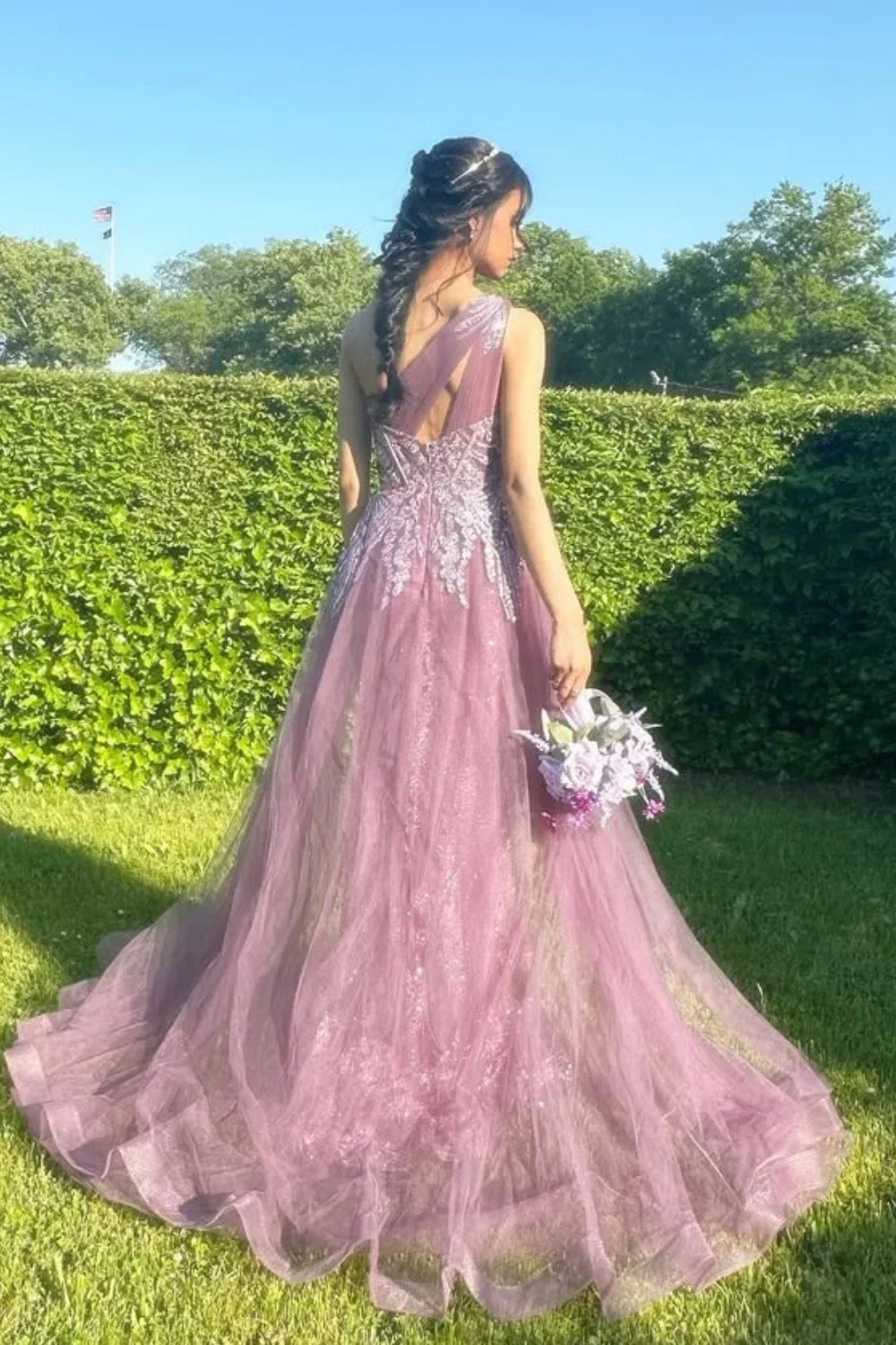 One-shoulder dusty rose A-line tulle gown featuring sequin embroidery and a structured corset bodice.