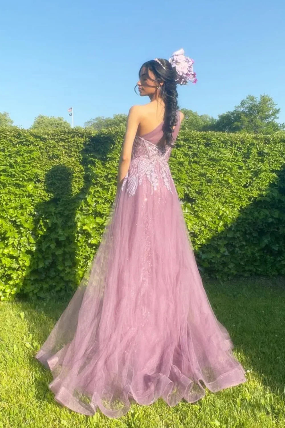 One-shoulder dusty rose A-line tulle gown featuring sequin embroidery and a structured corset bodice.
