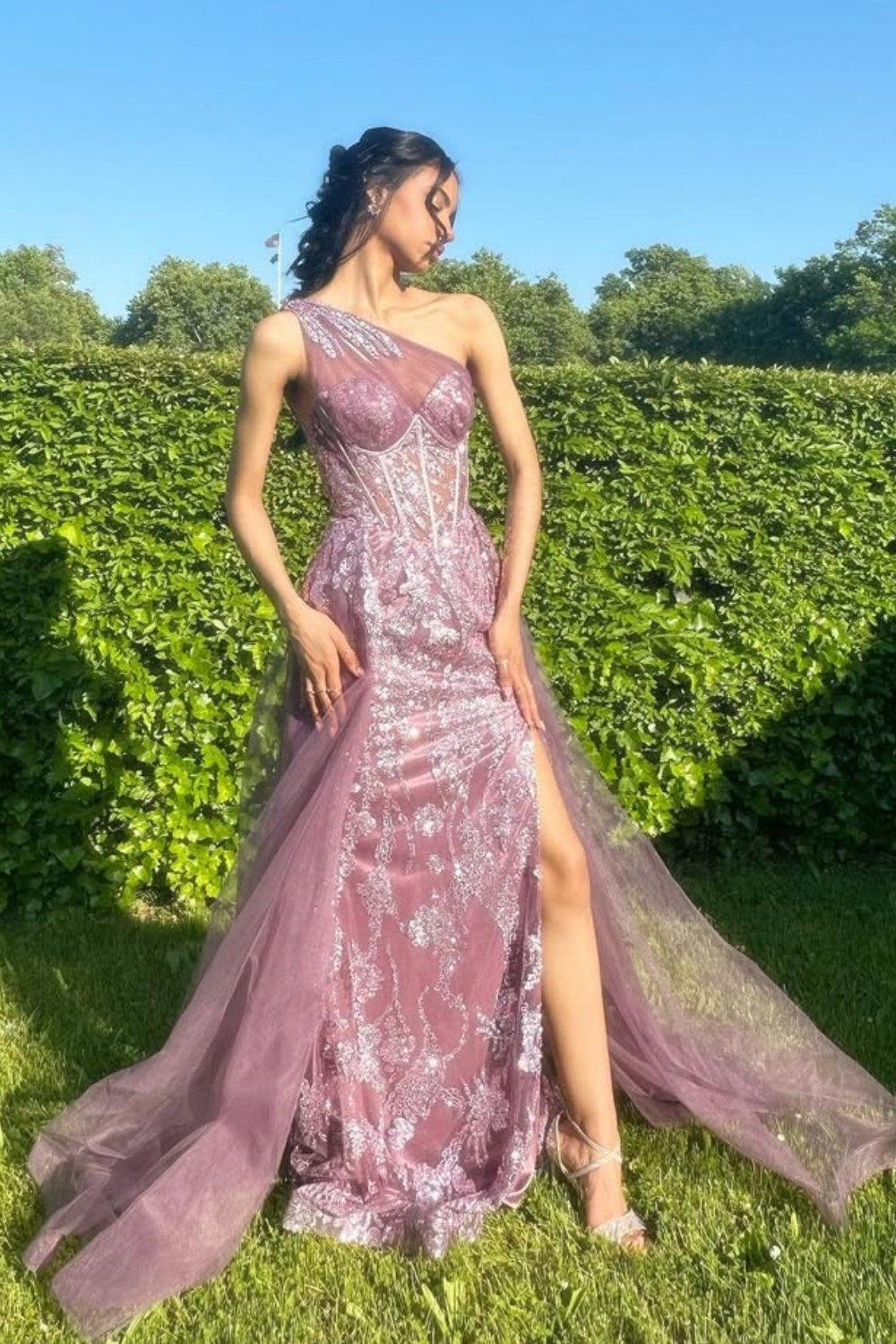 One-shoulder dusty rose A-line tulle gown featuring sequin embroidery and a structured corset bodice.