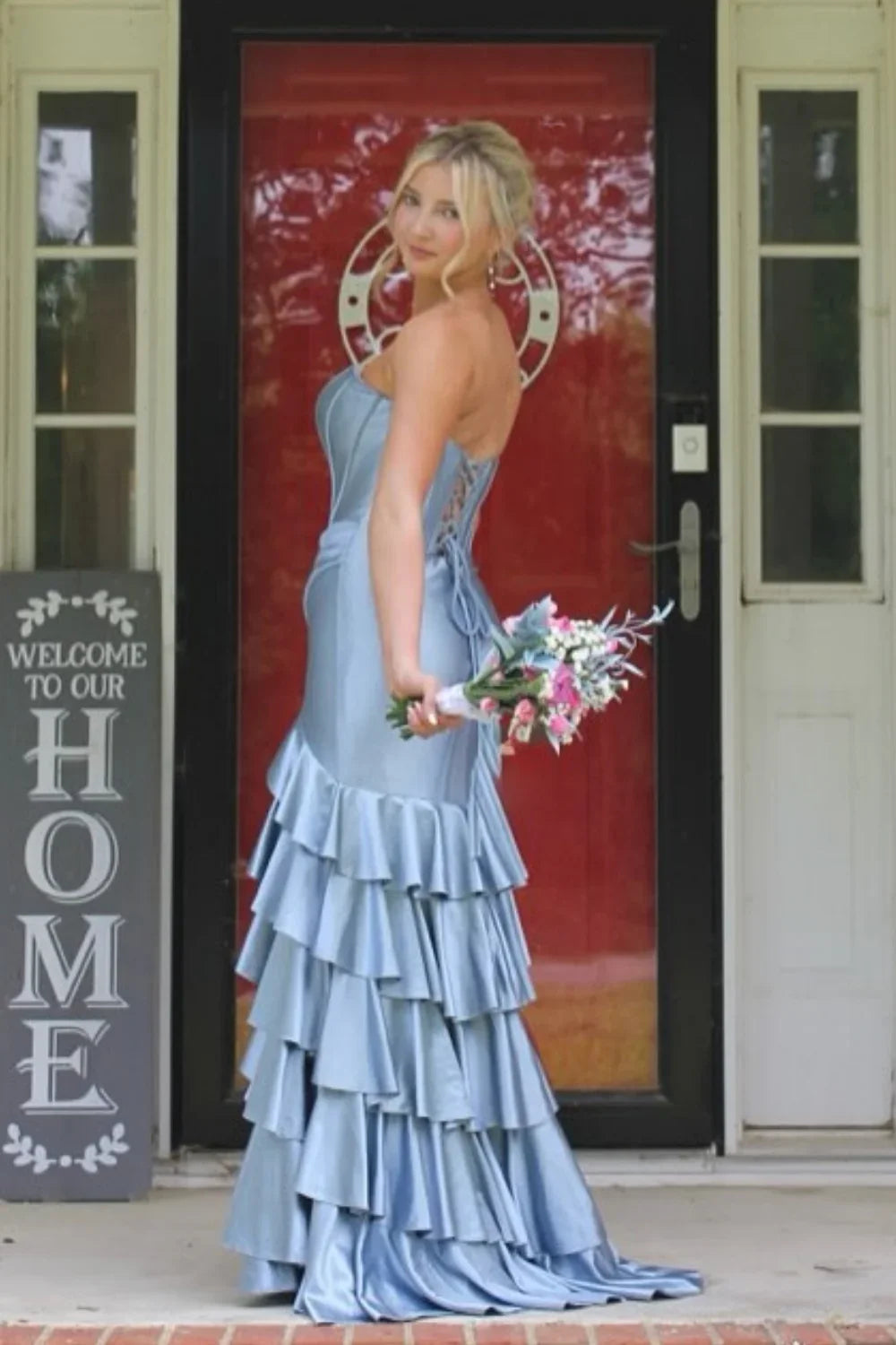 Romantic dusty blue A-line prom dress featuring a sweetheart neckline, tiered ruffle skirt, and adjustable lace-up back.