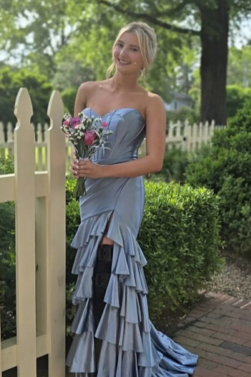 Romantic dusty blue A-line prom dress featuring a sweetheart neckline, tiered ruffle skirt, and adjustable lace-up back.
