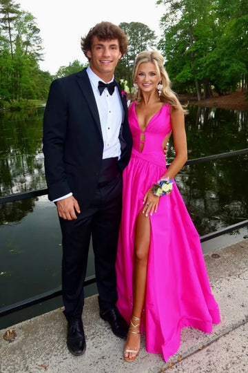 Vibrant hot pink formal gown featuring a plunging V-neckline, waist cut-outs, and a high leg slit.