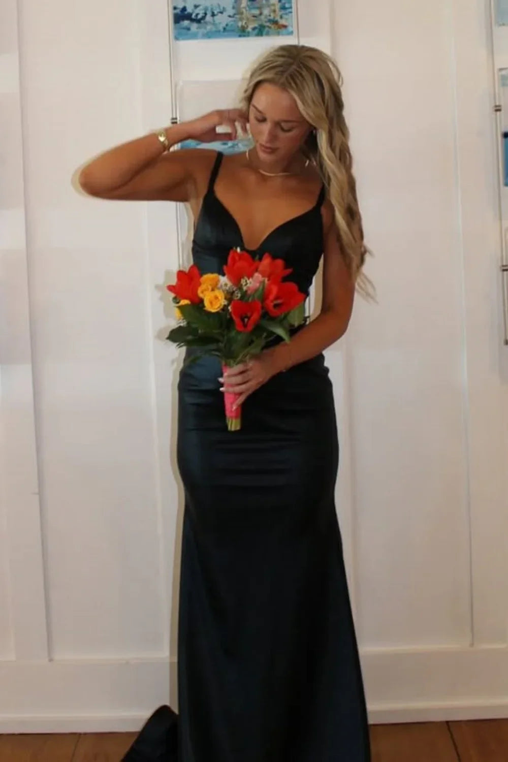 Sophisticated black mermaid formal dress featuring a plunging V-neckline, ruched detailing, and a low open back.