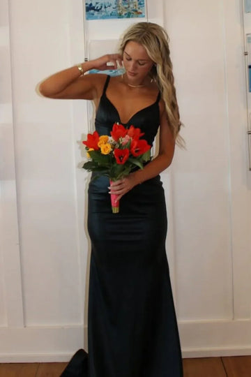 Sophisticated black mermaid formal dress featuring a plunging V-neckline, ruched detailing, and a low open back.