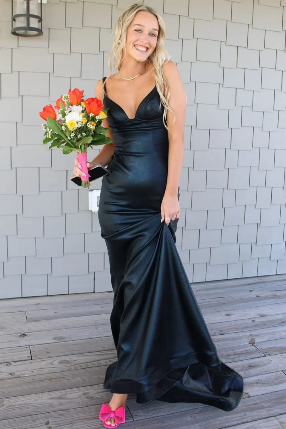 Sophisticated black mermaid formal dress featuring a plunging V-neckline, ruched detailing, and a low open back.