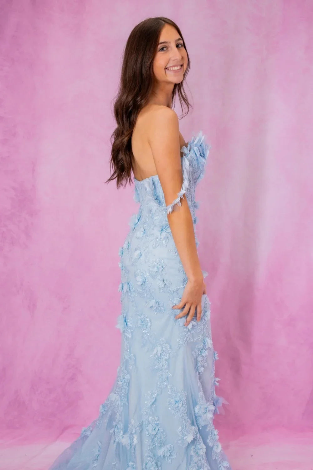Blue mermaid prom dress featuring a sweetheart neckline, intricate 3D floral accents, and shimmering beadwork.