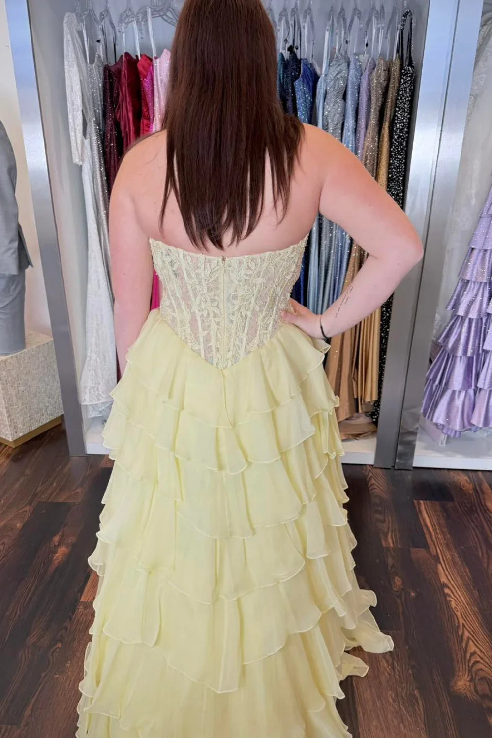 Elegant yellow chiffon ball gown featuring a strapless illusion bodice adorned with delicate lace appliques.
