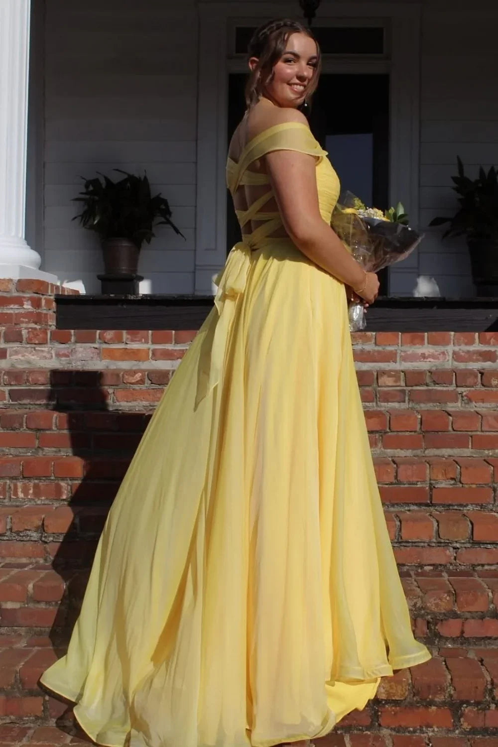 Radiant yellow A-line chiffon prom gown featuring an off-the-shoulder neckline, pleated bodice, and illusion details.