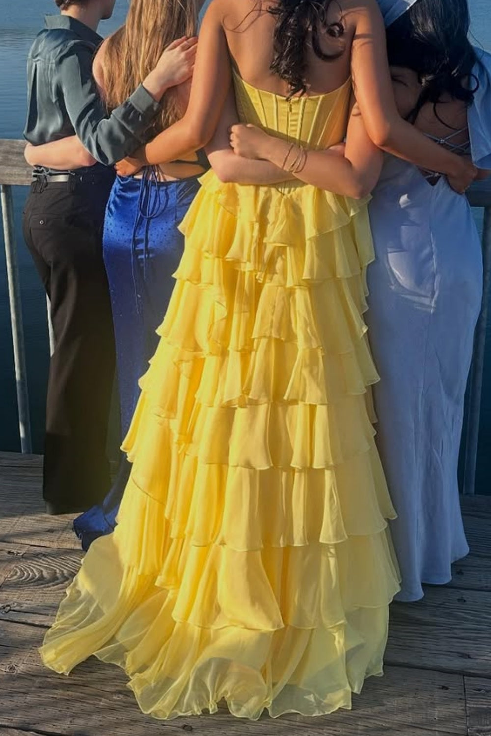 Bright yellow A-line formal gown featuring a sweetheart neckline, intricate lace appliques, and a voluminous tiered skirt.