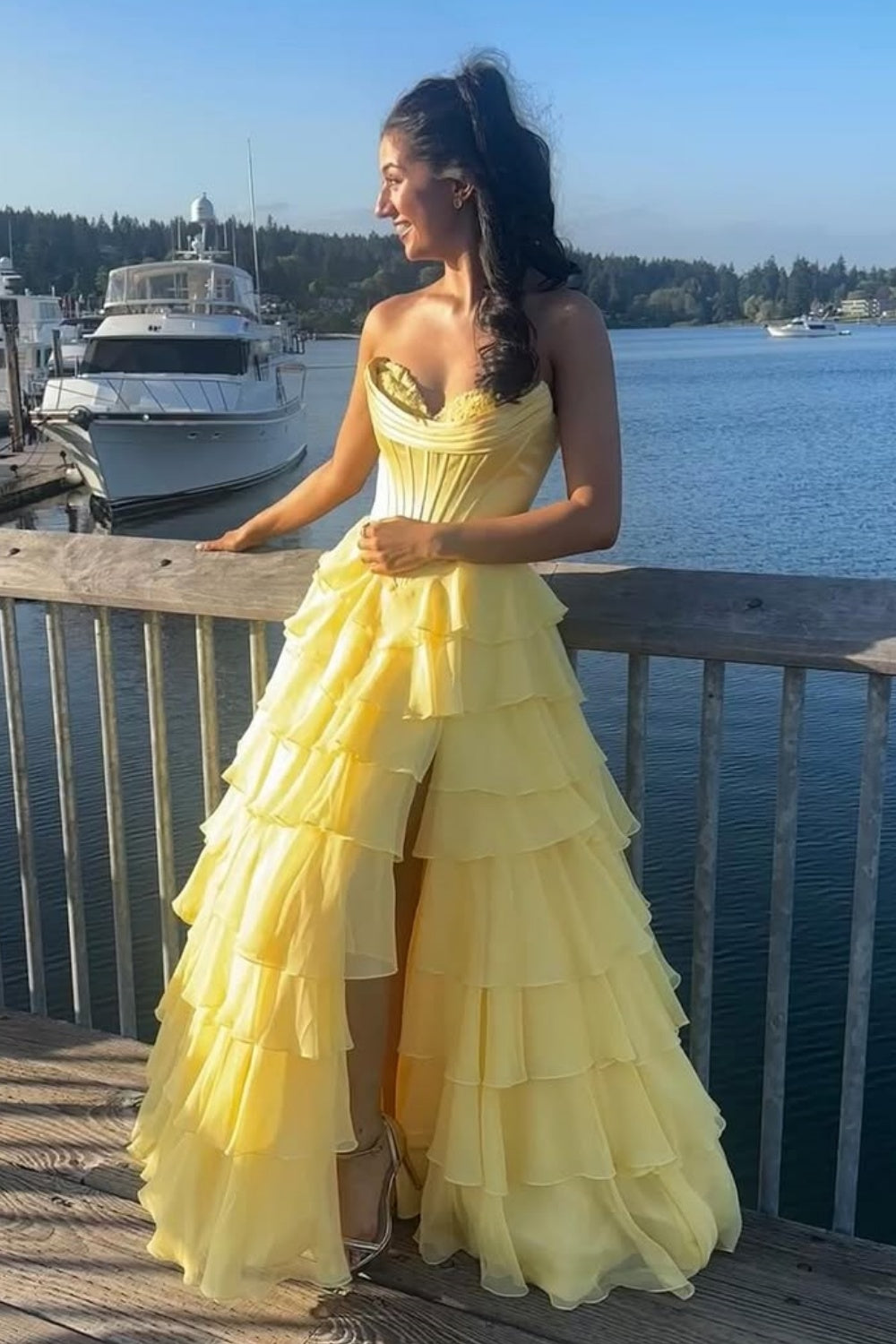 Bright yellow A-line formal gown featuring a sweetheart neckline, intricate lace appliques, and a voluminous tiered skirt.