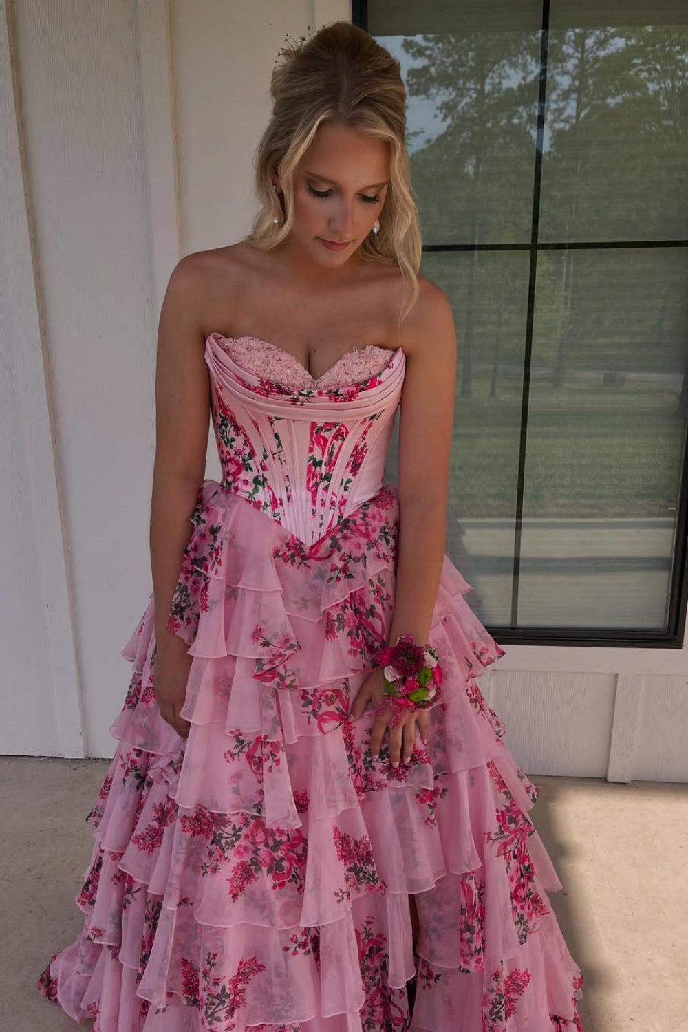 Floral print chiffon A-line gown with lace appliques and ruffled slit.