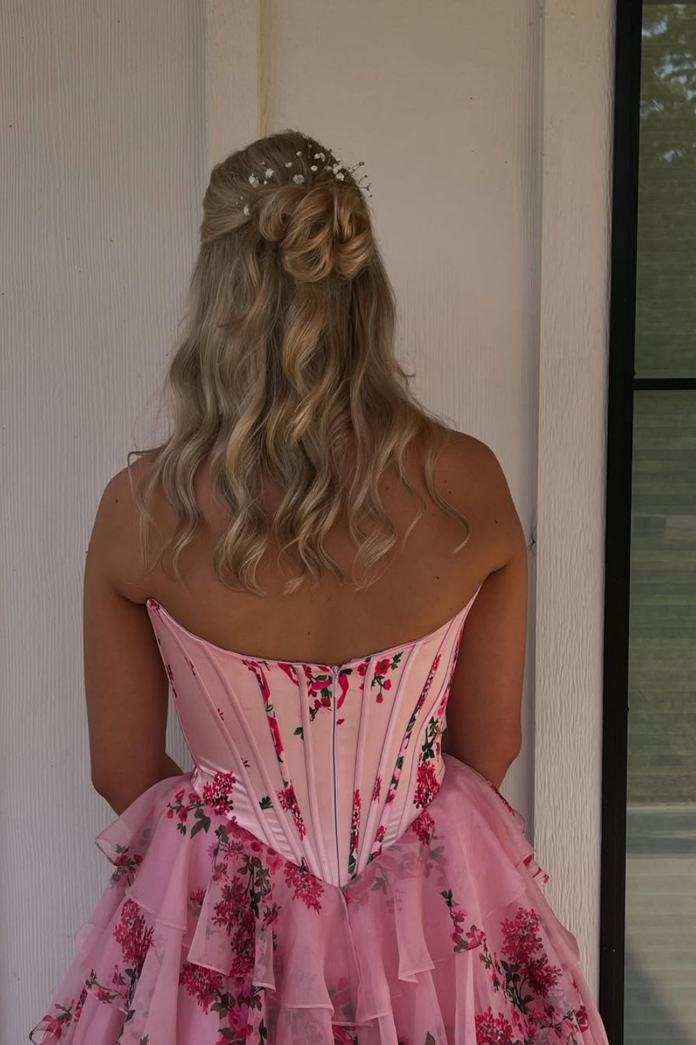 Floral print chiffon A-line gown with lace appliques and ruffled slit.