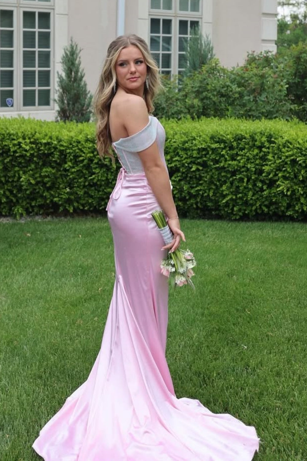Pink off-the-shoulder mermaid dress with ruched corset and lace-up back.