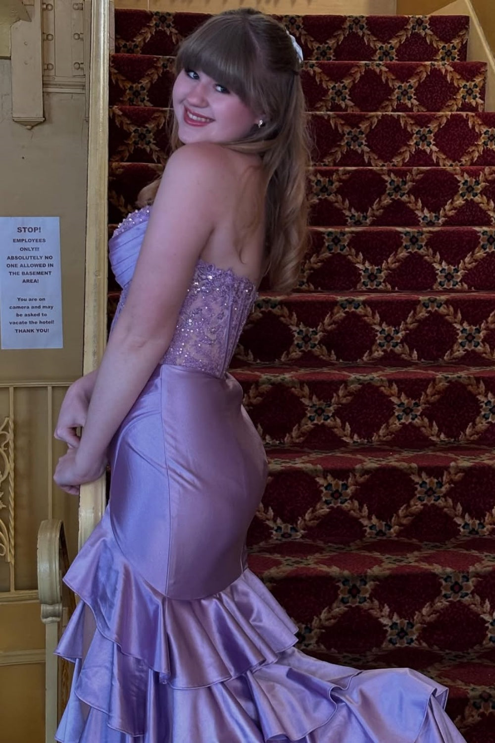 Purple strapless A-line dress with beaded illusion corset and ruffles.