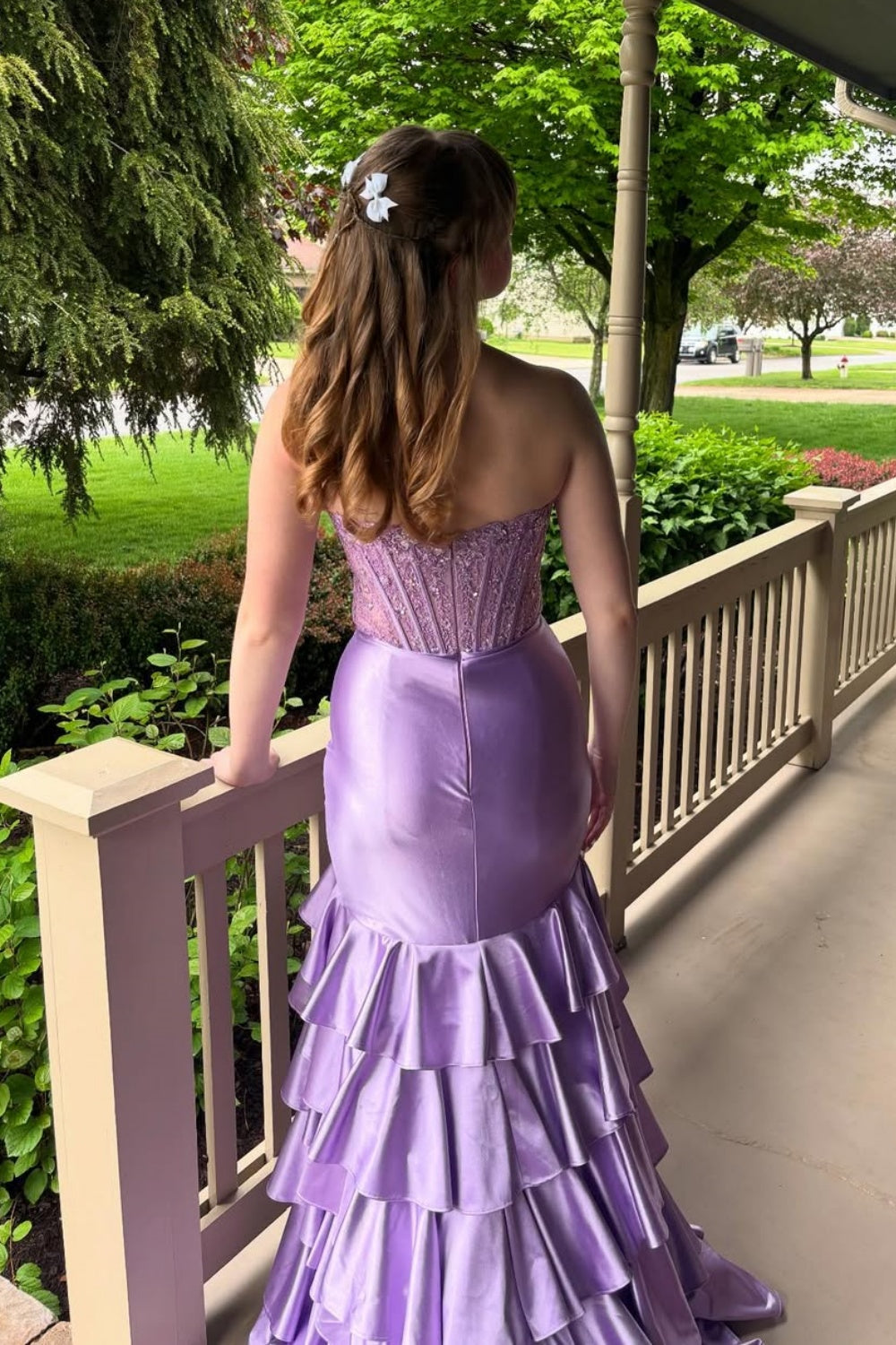 Purple strapless A-line dress with beaded illusion corset and ruffles.