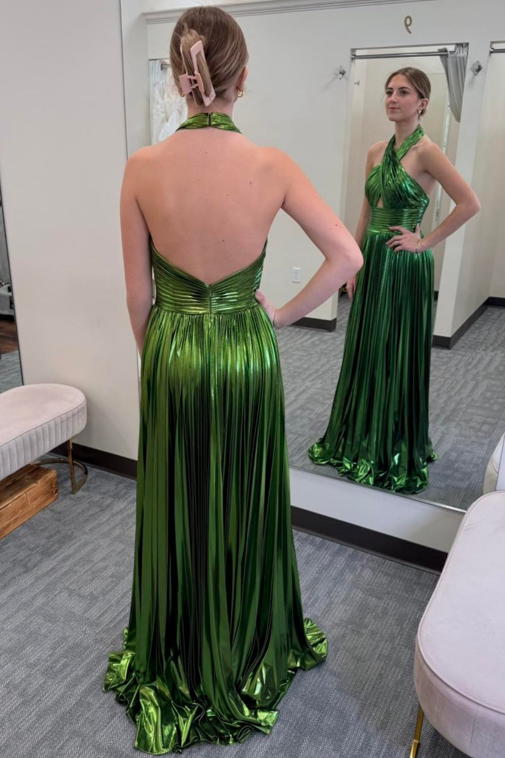 Metallic green halter A-line pleated formal dress with leg slit and open back.