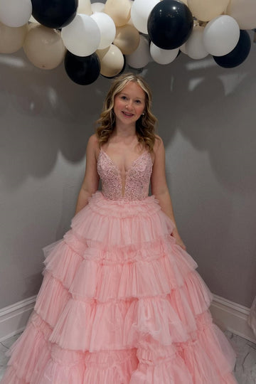 Pink tiered puff ball gown with spaghetti straps and lace appliques.