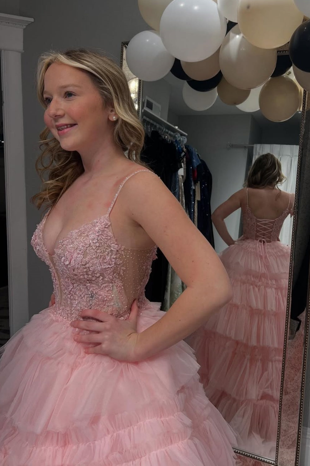 Pink tiered puff ball gown with spaghetti straps and lace appliques.