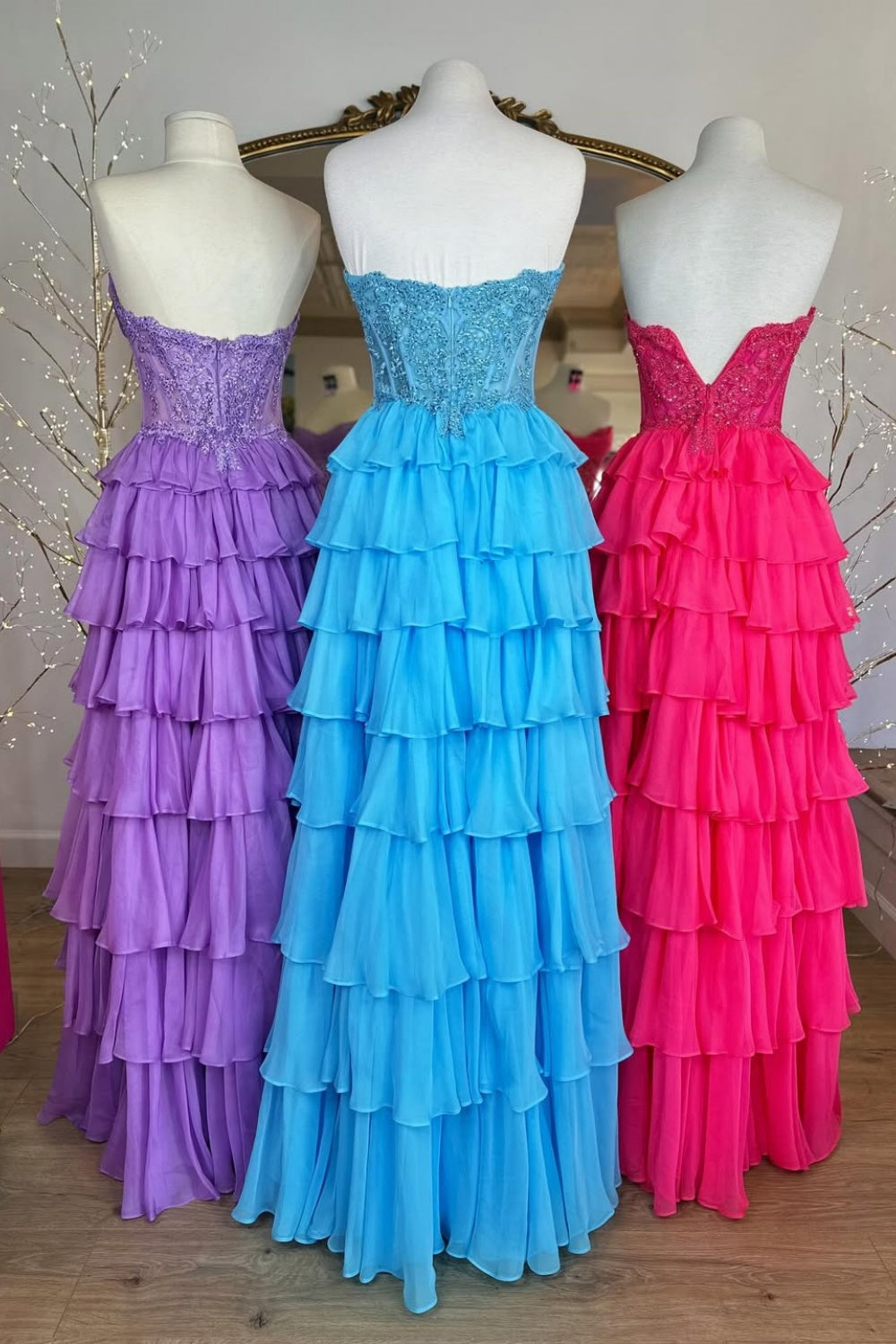 A-line tiered chiffon gown featuring a cowl neck and beaded lace appliques.