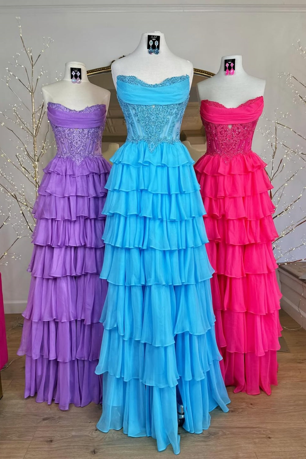 A-line tiered chiffon gown featuring a cowl neck and beaded lace appliques.