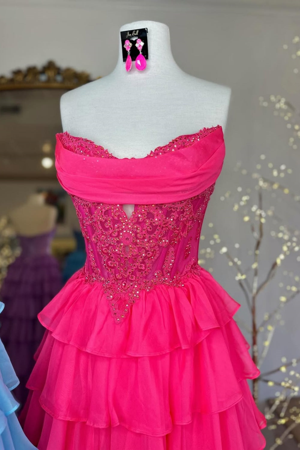A-line tiered chiffon gown featuring a cowl neck and beaded lace appliques.