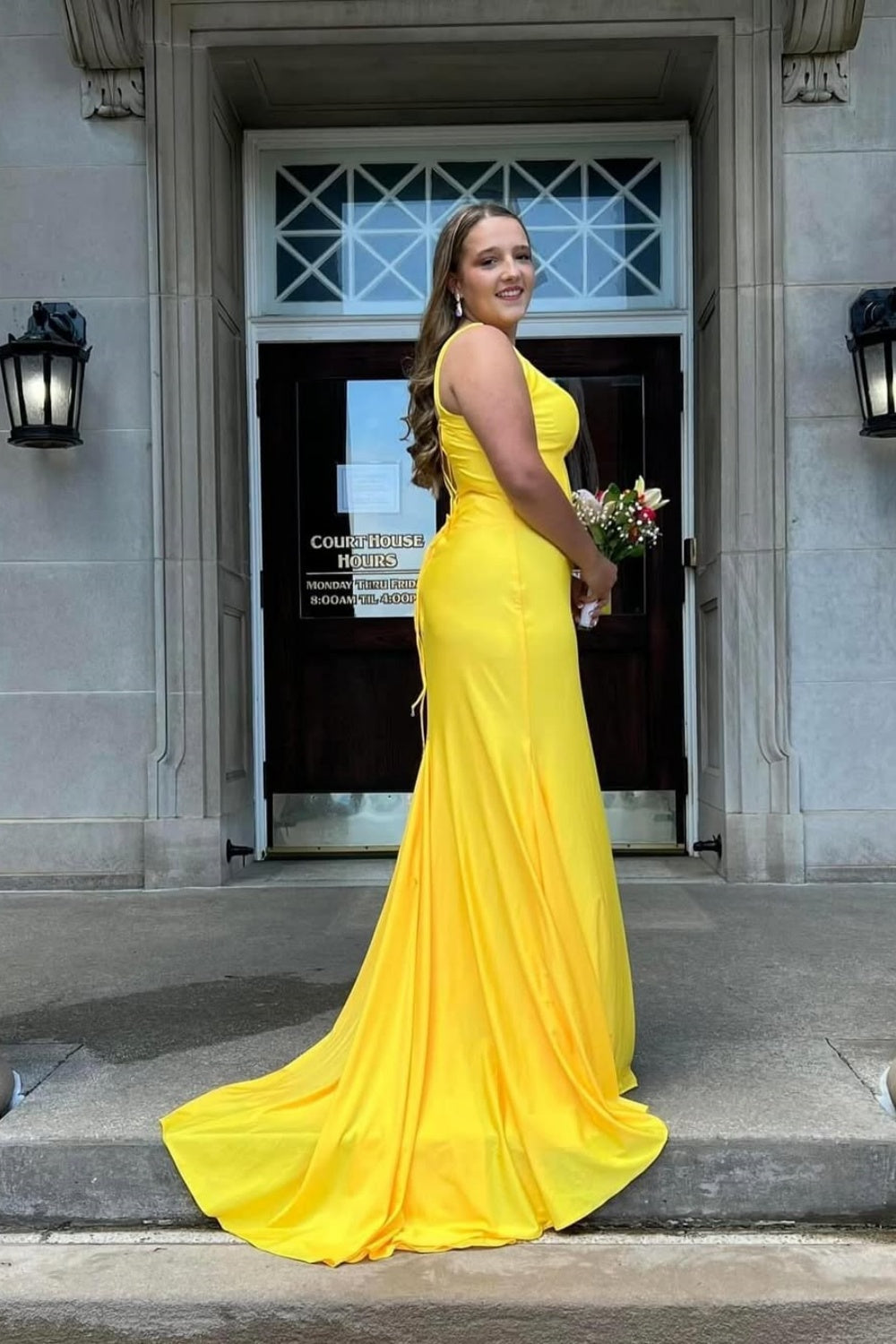 Yellow mermaid satin prom dress with a plunging V-neck and lace-up back