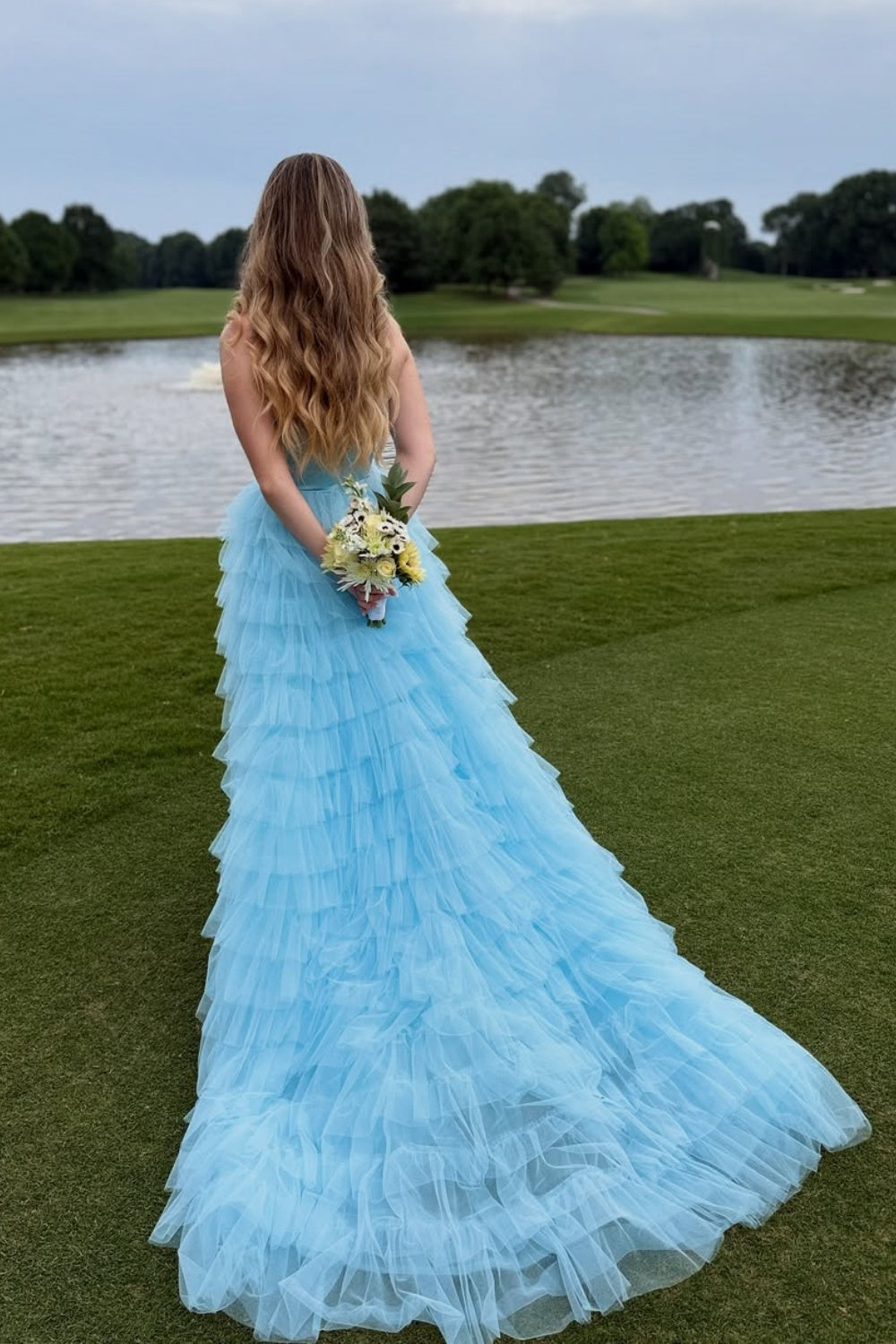 Light blue sweetheart A-line prom gown with beaded bodice and ruffled tulle skirt.
