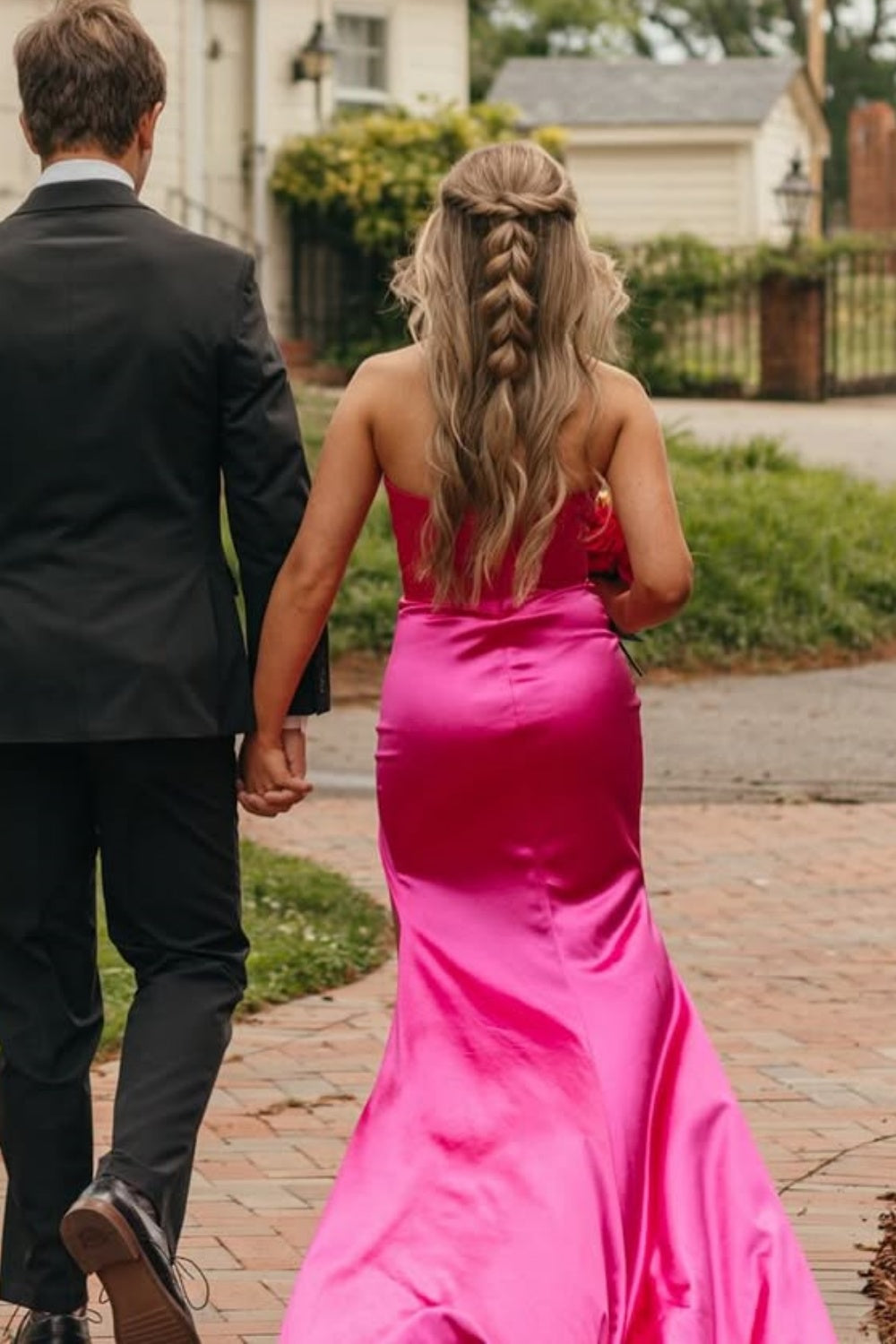 Blush pink mermaid prom dress with a plunging V-neck, beaded details, and leg slit.