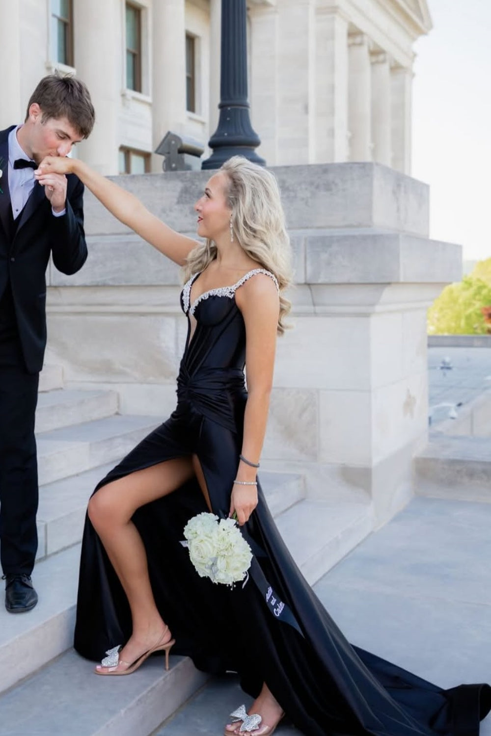 Black mermaid prom dress featuring a beaded plunging V-neck and leg slit.