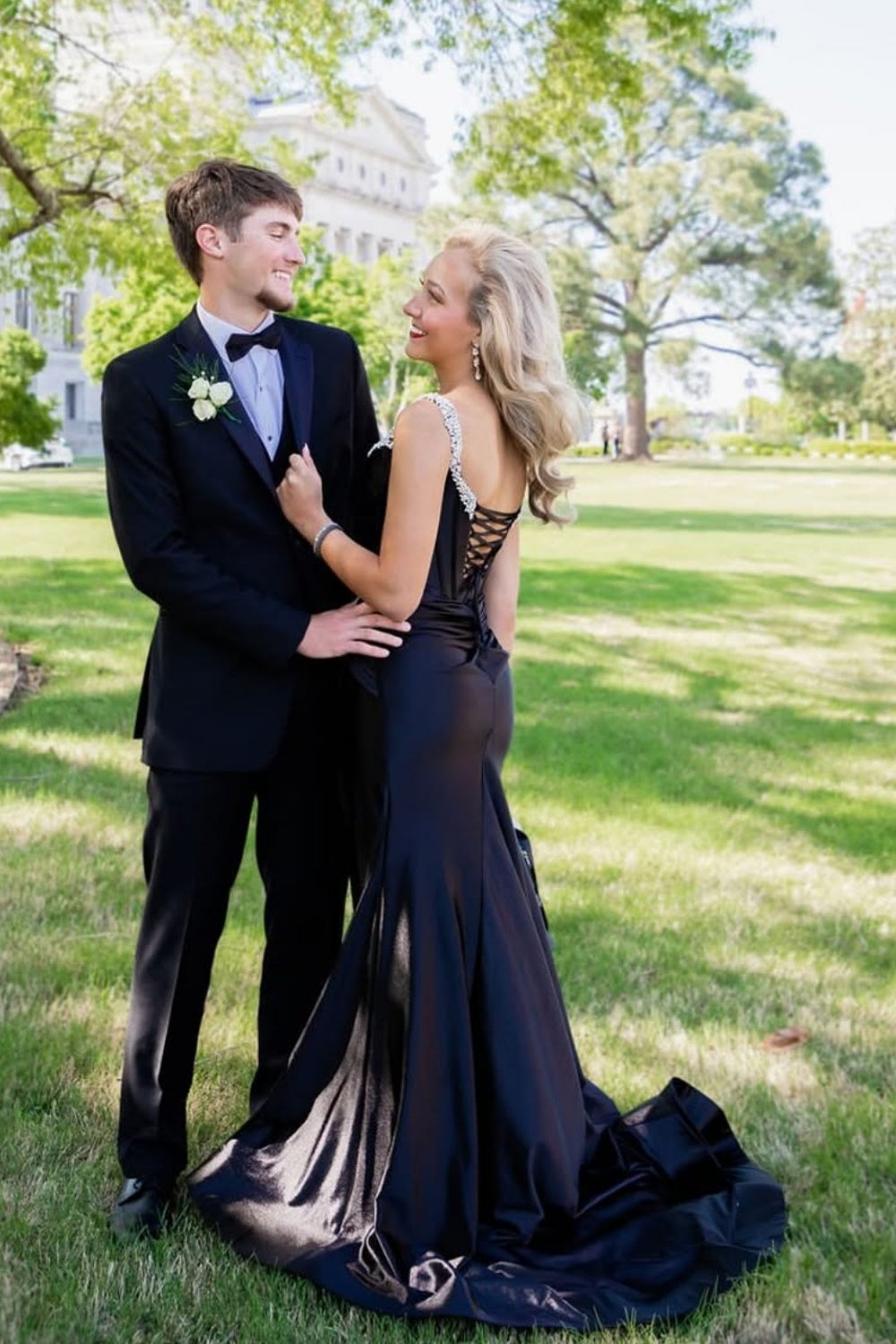 Black mermaid prom dress featuring a beaded plunging V-neck and leg slit.