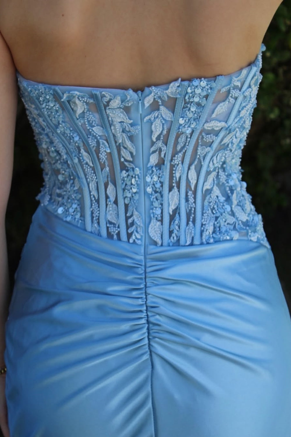 Light blue strapless mermaid prom gown with intricate lace appliques and silver beadwork.