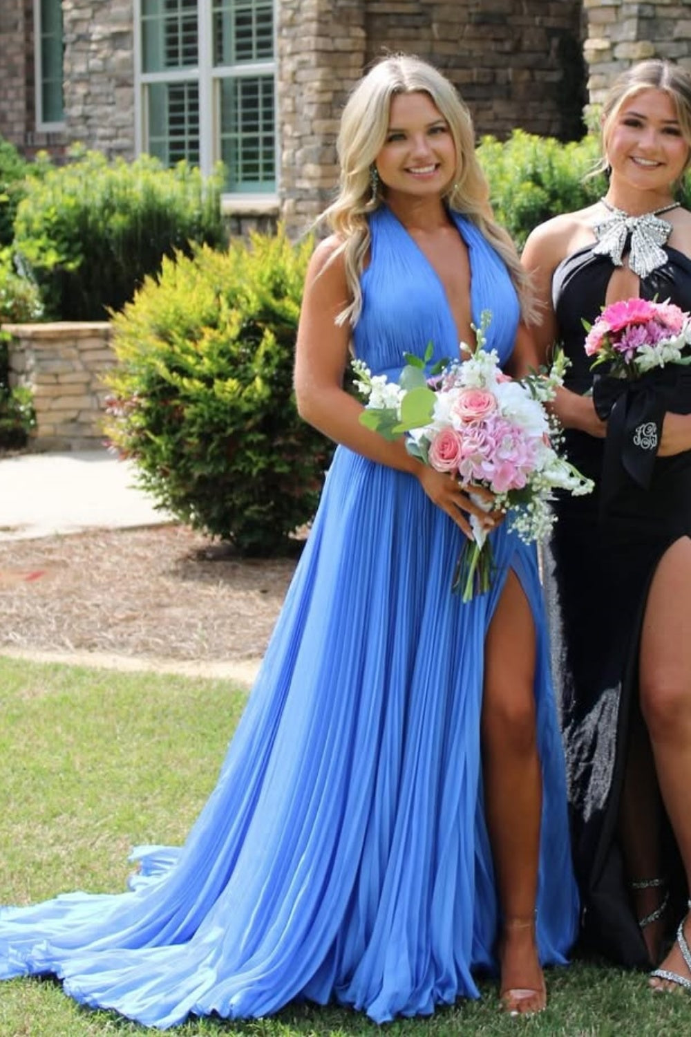 Halter neck pleated chiffon A-line gown with open back and side slit.