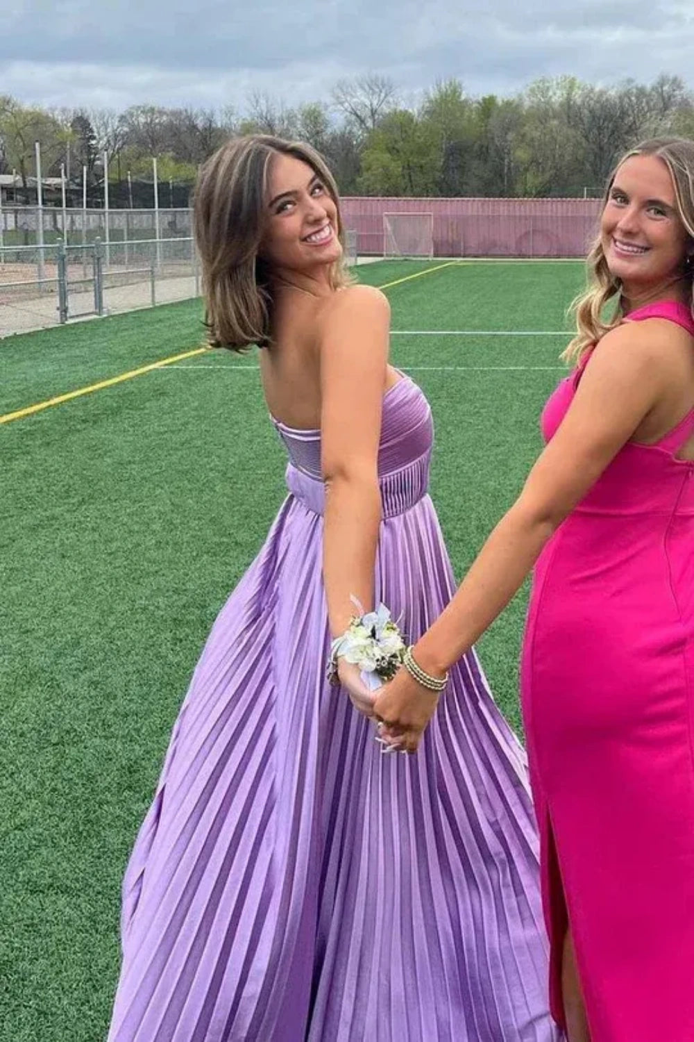 Purple strapless A-line prom dress featuring a pleated bodice and high side slit.