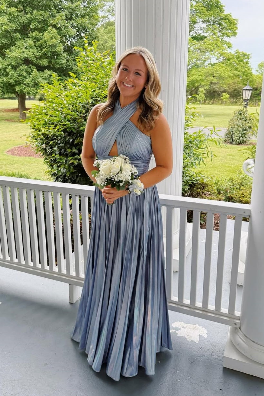 Silver A-line formal gown with criss-cross pleated bodice and keyhole neckline.