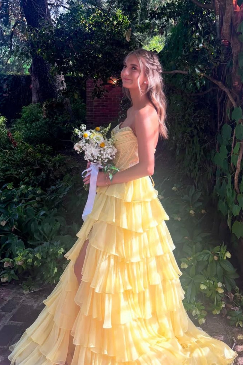 Yellow strapless A-line floor-length chiffon gown with corset bodice and beaded ruffles.