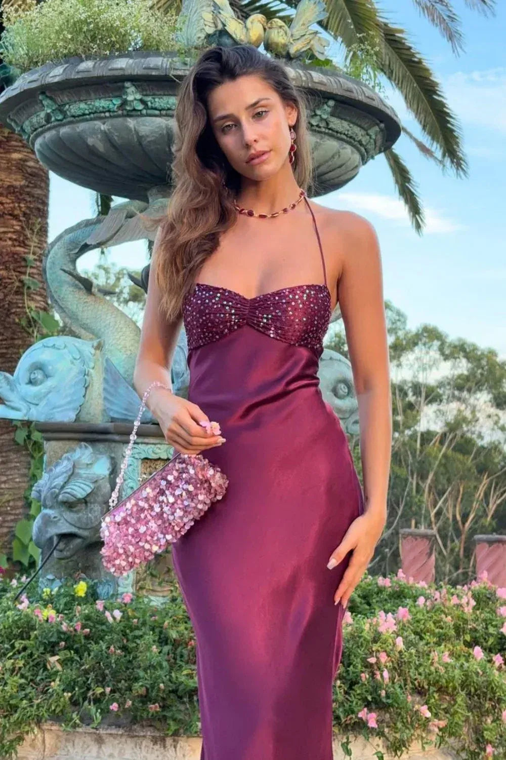 Purple halter neck fitted long prom dress with shimmering sequins and lace-up back.