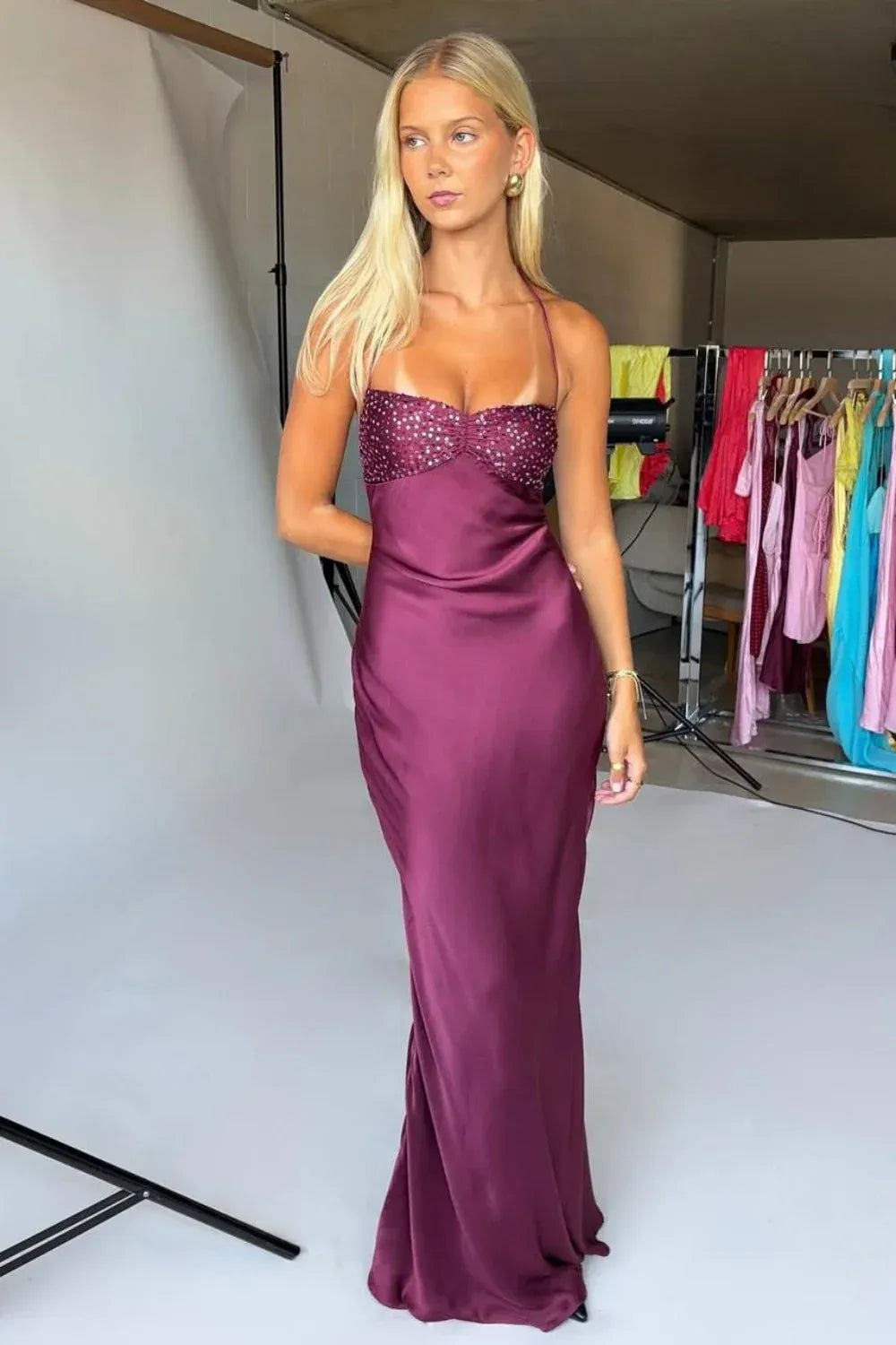 Purple halter neck fitted long prom dress with shimmering sequins and lace-up back.