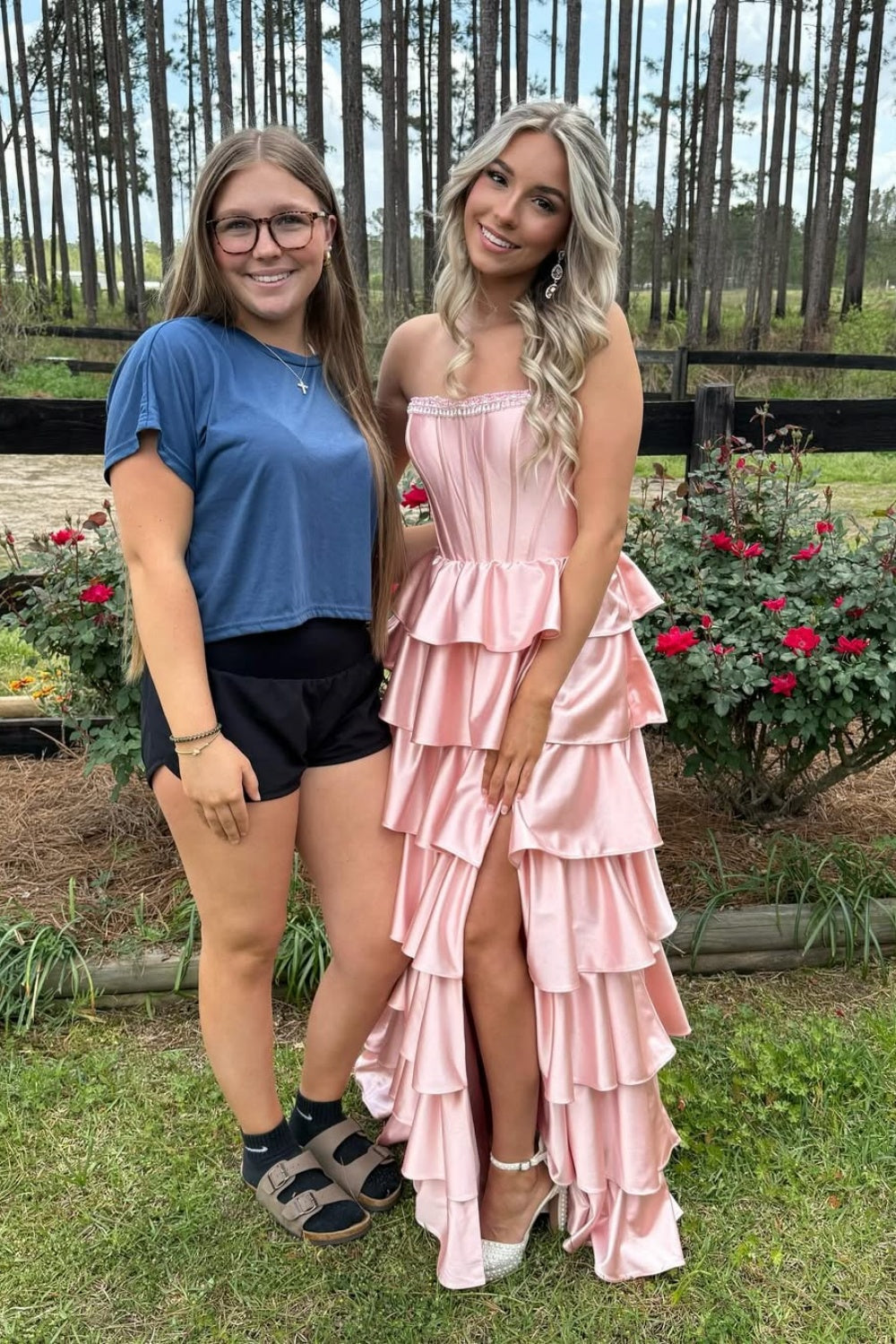 Pink strapless A-line tiered formal dress with a side slit and zipper-back.