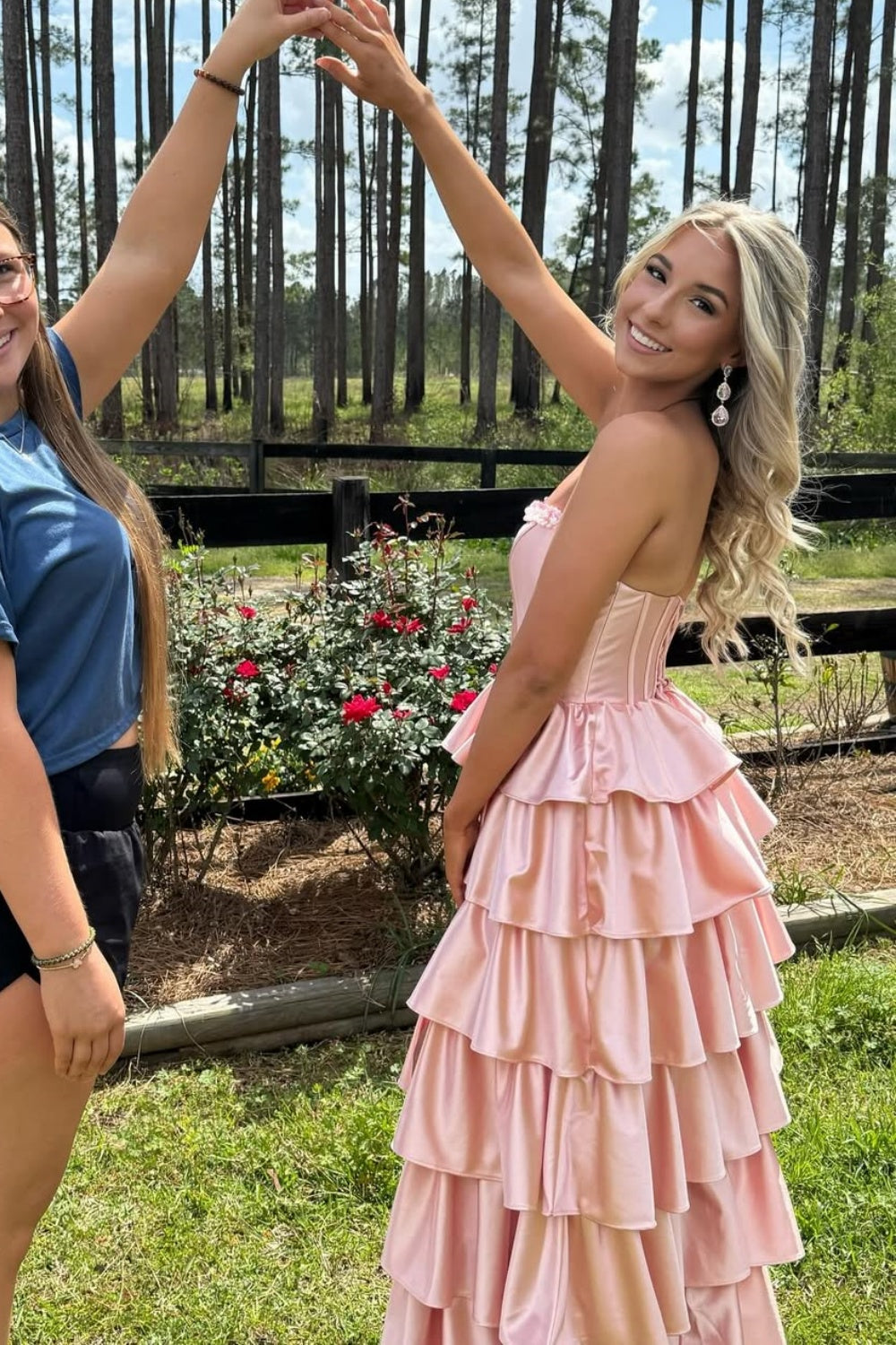 Pink strapless A-line tiered formal dress with a side slit and zipper-back.