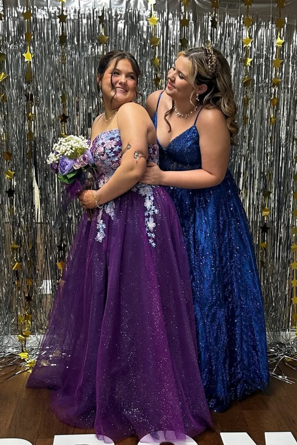 Plus size purple tulle prom dress with spaghetti straps, floral appliques, and sequins.